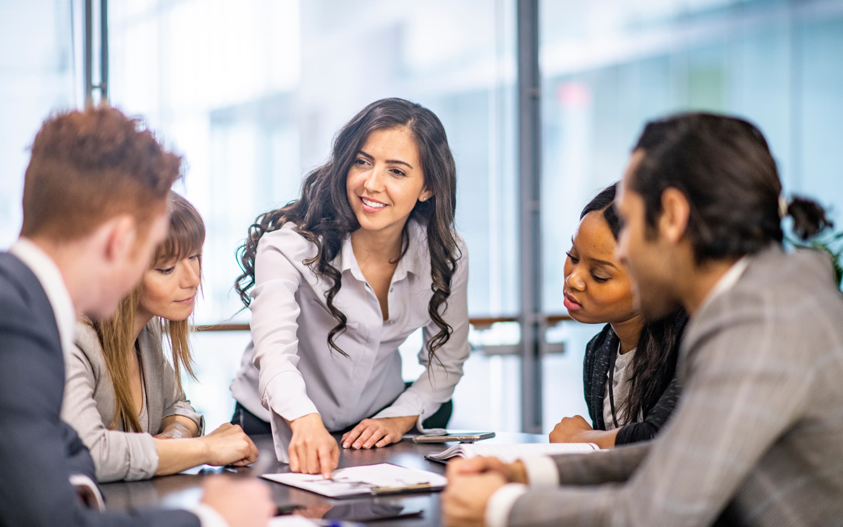 A diverse team collaborating around a table in a modern office